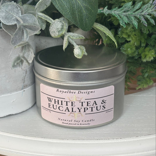Candle in a tin labeled 'White Tea & Eucalyptus' sold by Royalbee Designs